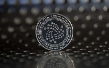 Iota-cryptocurrency-physical-coin-placed-on-the-metal-surface-with-holes Iota-cryptocurrency-physical-coin-placed-on-the-metal-surface-with-holes