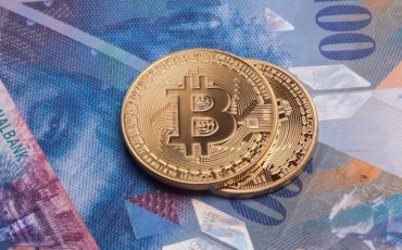 Bitcoin btc crypto currency coin over swiss francs bank notes Bitcoin btc crypto currency coin over swiss francs bank notes