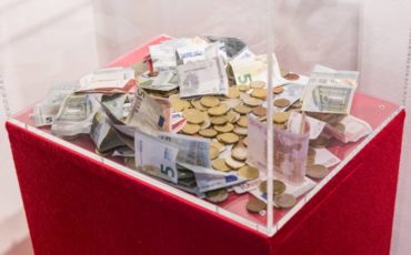 Donation Plastic box with donations in euro bills and coins